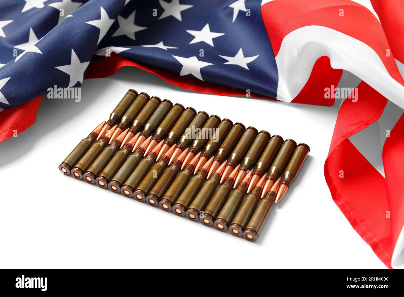 American flag, bullets, ammunition, cartridges for firearms on a white background. The concept of lend-lease, support, arms sales. Stock Photo