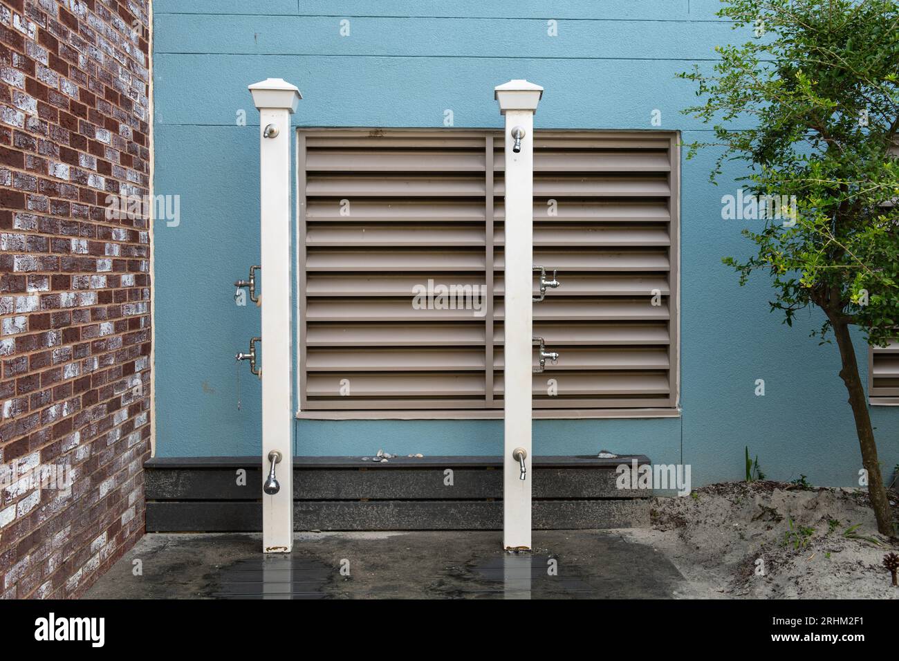 Outdoor beach showers provided by a hotel for guests to clean up after