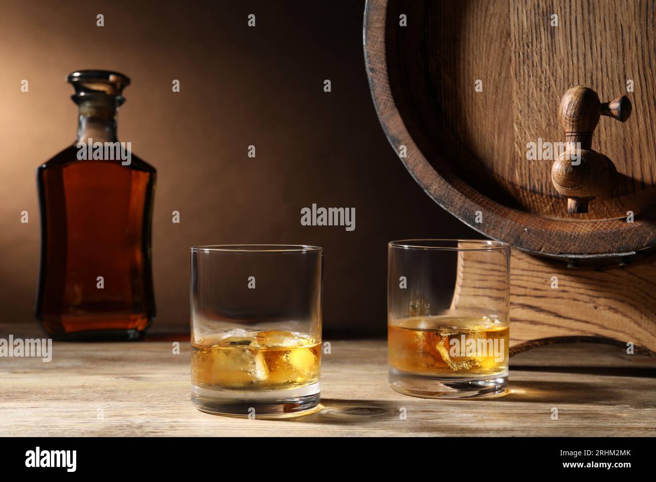Barrel with tap and tasty whiskey on wooden table Stock Photo