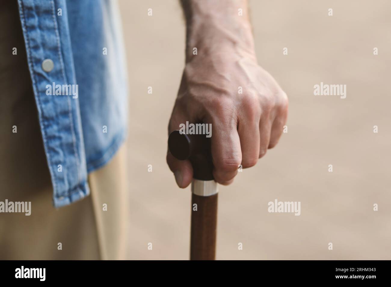 Senior man with walking cane outdoors, closeup Stock Photo - Alamy