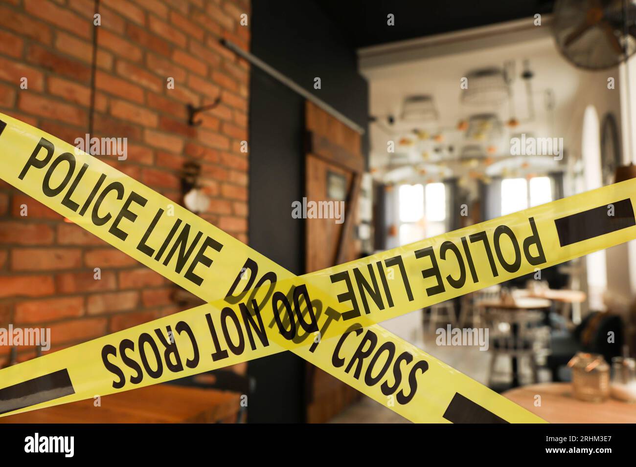 Yellow crime scene tape in empty restaurant Stock Photo