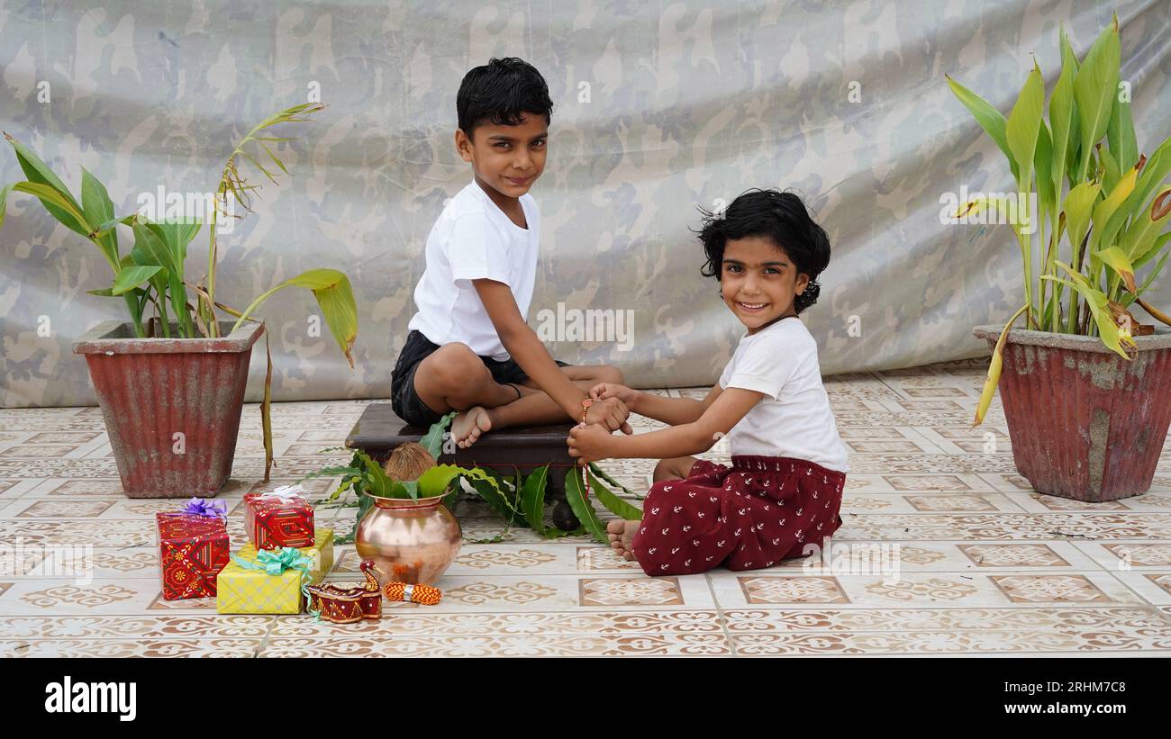 Indian good looking teenager brother and sister celebrating Raksha Bandhan or Rakhi festival. Stock Photo