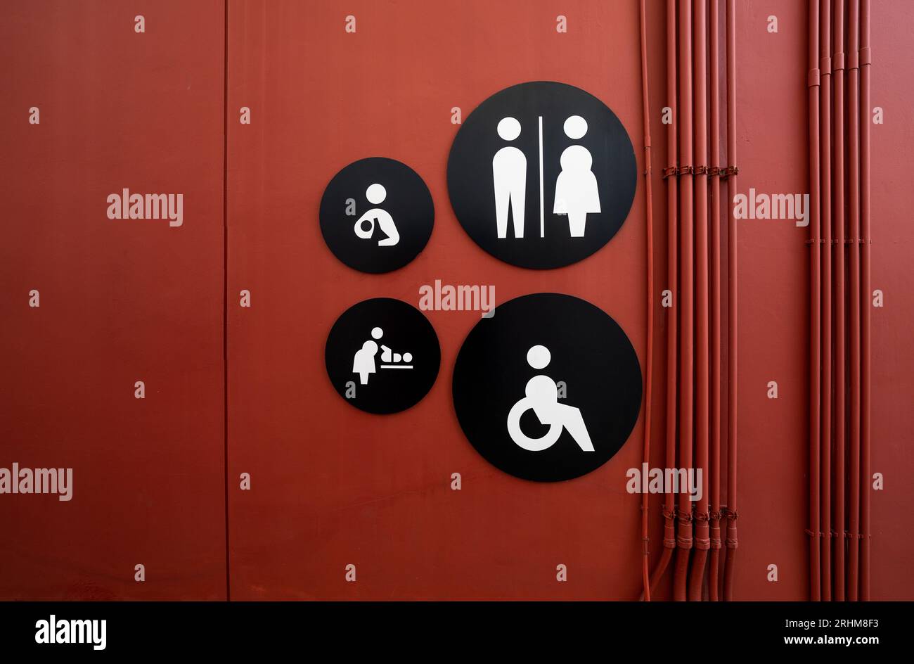 Public toilet sign. Woman, men, children, baby diaper changing, and disabled person toilet icon on restroom wall. Public restroom universal icon. Stock Photo