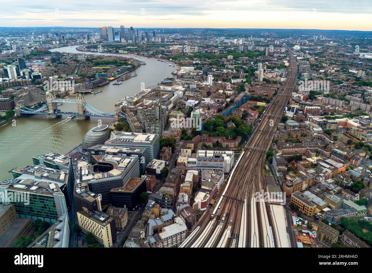London, England, UK - July 26, 2023. Aerial panoramic view, a cityscape of the modern London skyline with boats on the River Thames and Tower Bridge. Stock Photo