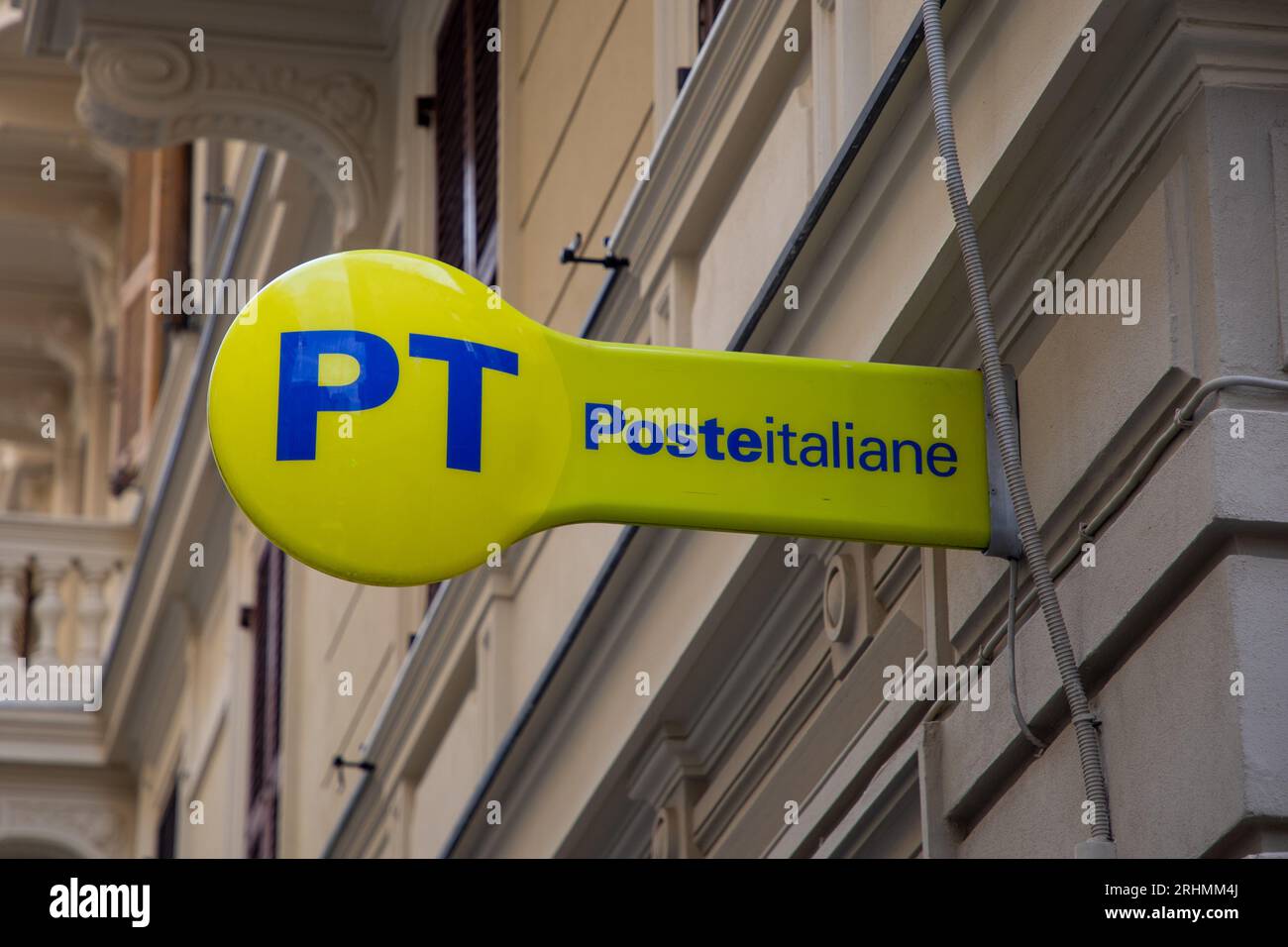 Milan , Italy 08 17 2023 poste italiane yellow logo brand and text sign on wall facade