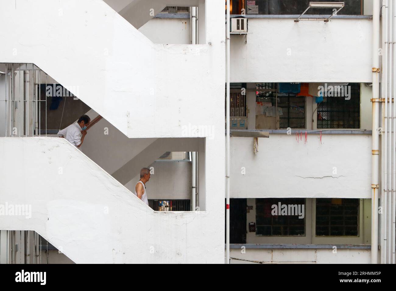 August 18, 2023, Hong Kong, Hong Kong, Hong Kong: Two elderly men using the staircase in Mirador Mansion ''“ a historic building comprised of residences, affordable guesthouses and small businesses. The complex on Nathan Road that features Hong Kong's densely populated population was established in 1959, where manufactures for watches or gloves and tailor shops there flourished during the industrialisation between the 50s and 70s. But now there are only a few tailor shops left, and most of the flats are being transformed into guesthouses. (Credit Image: © Daniel Ceng Shou-Yi/ZUMA Press Wire) E Stock Photo