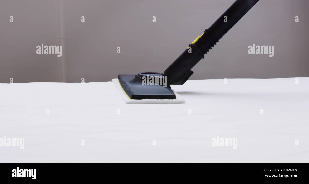Cleaning Bed Mattress With Steam Machine. Bed Bugs Treatment Stock