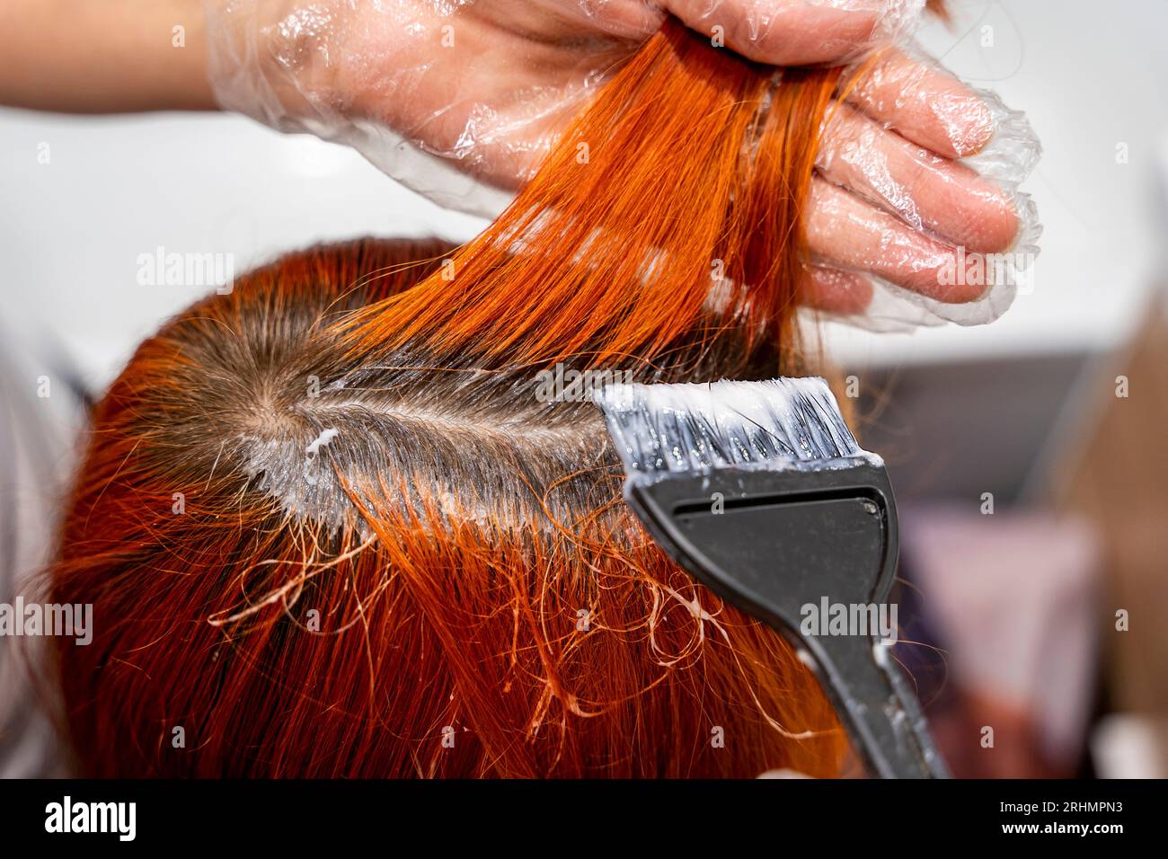 Closeup Of A Strand Of Female Hair On A Special Sheet Of Foil The Master  Applies Hair Dye With A Brush The Process Of Highlighting By A Professional  Master In A Beauty