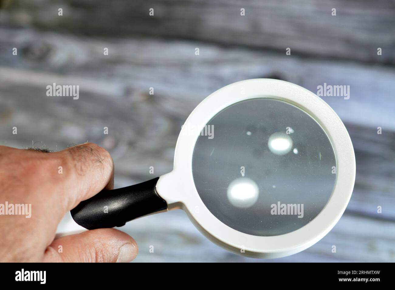 A magnifying glass, a convex lens that is used to produce a magnified
