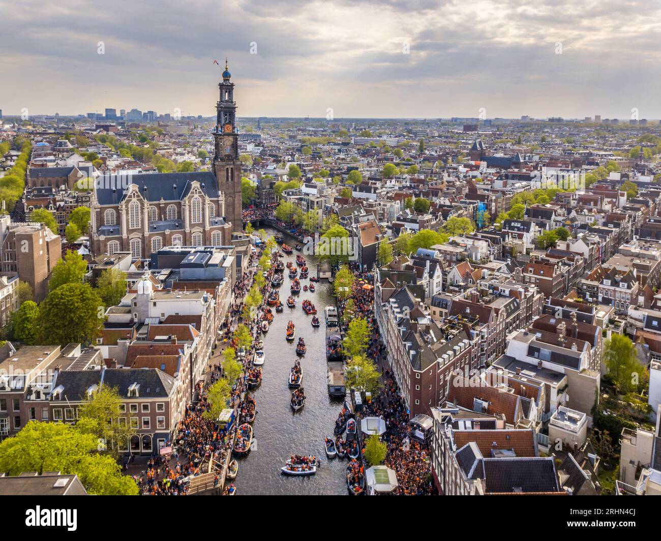 Amsterdam aerial view of Westerkerk church seen from north on Koningsdag Kings day festivities. Birthday of the king. Seen from helicopter. Stock Photo