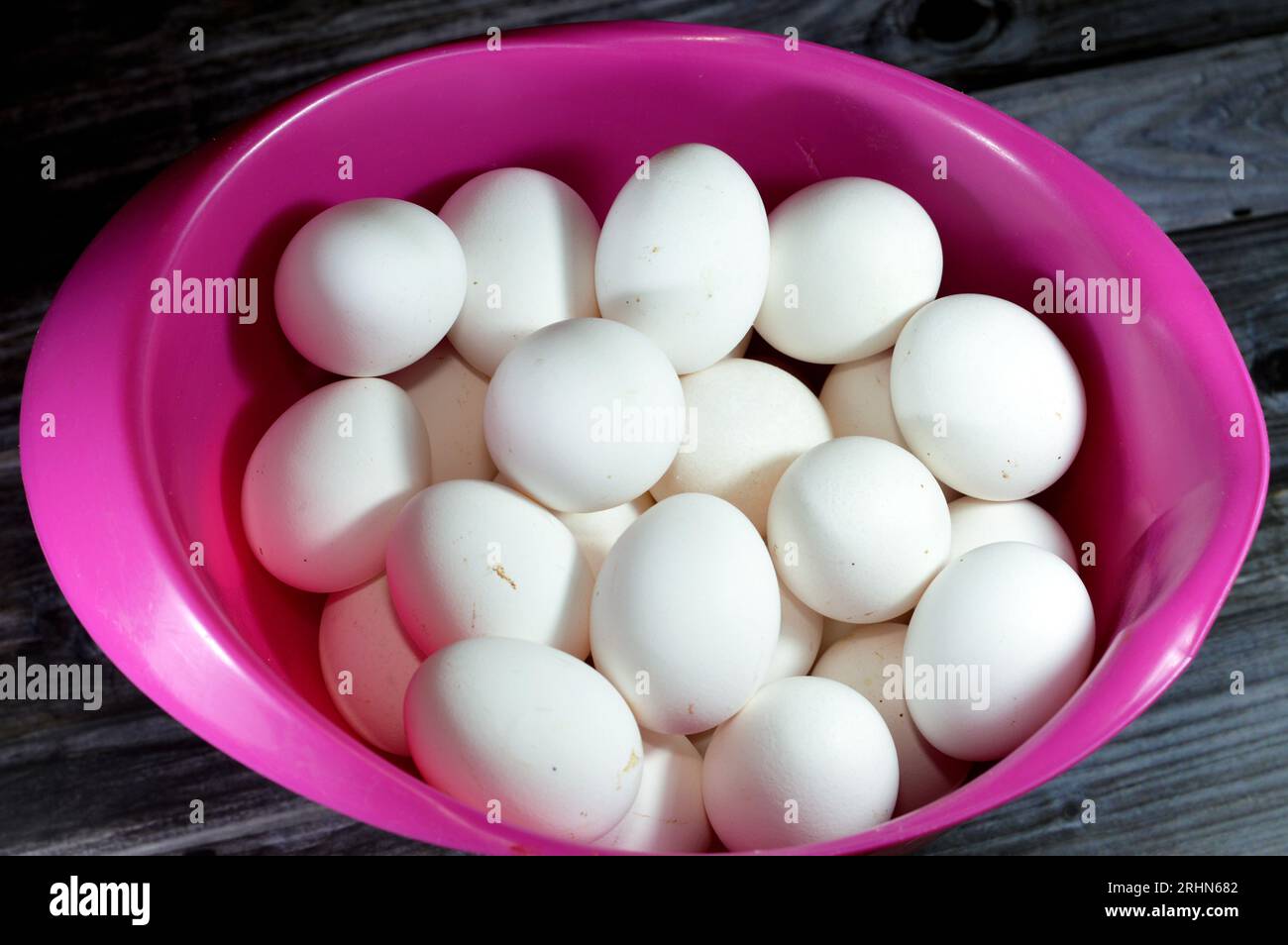 Pile of organic fresh and raw hen chicken white eggs, stack of eggs isolated and ready to be cooked in various cuisines, selective focus of eggs which Stock Photo