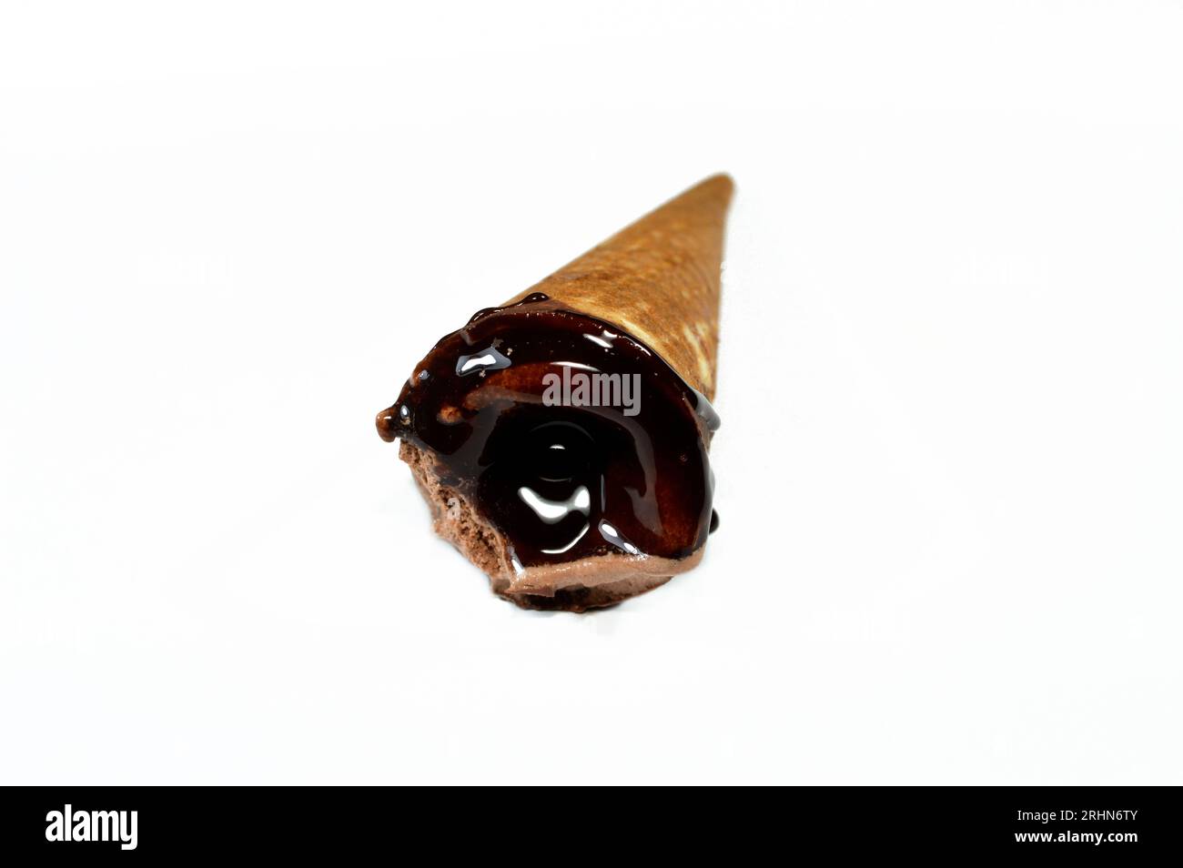 Ice cream of creamy cocoa chocolate cone with topping of chocolate sauce and brownie pieces in a