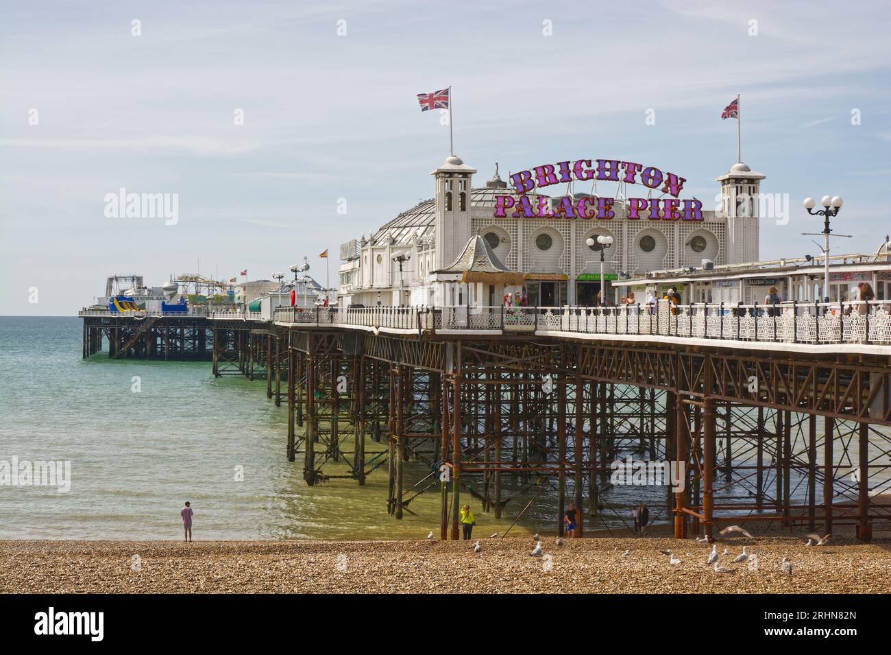 Brighton Palace Pier in East Sussex, England. With people on beach and pier. Stock Photo