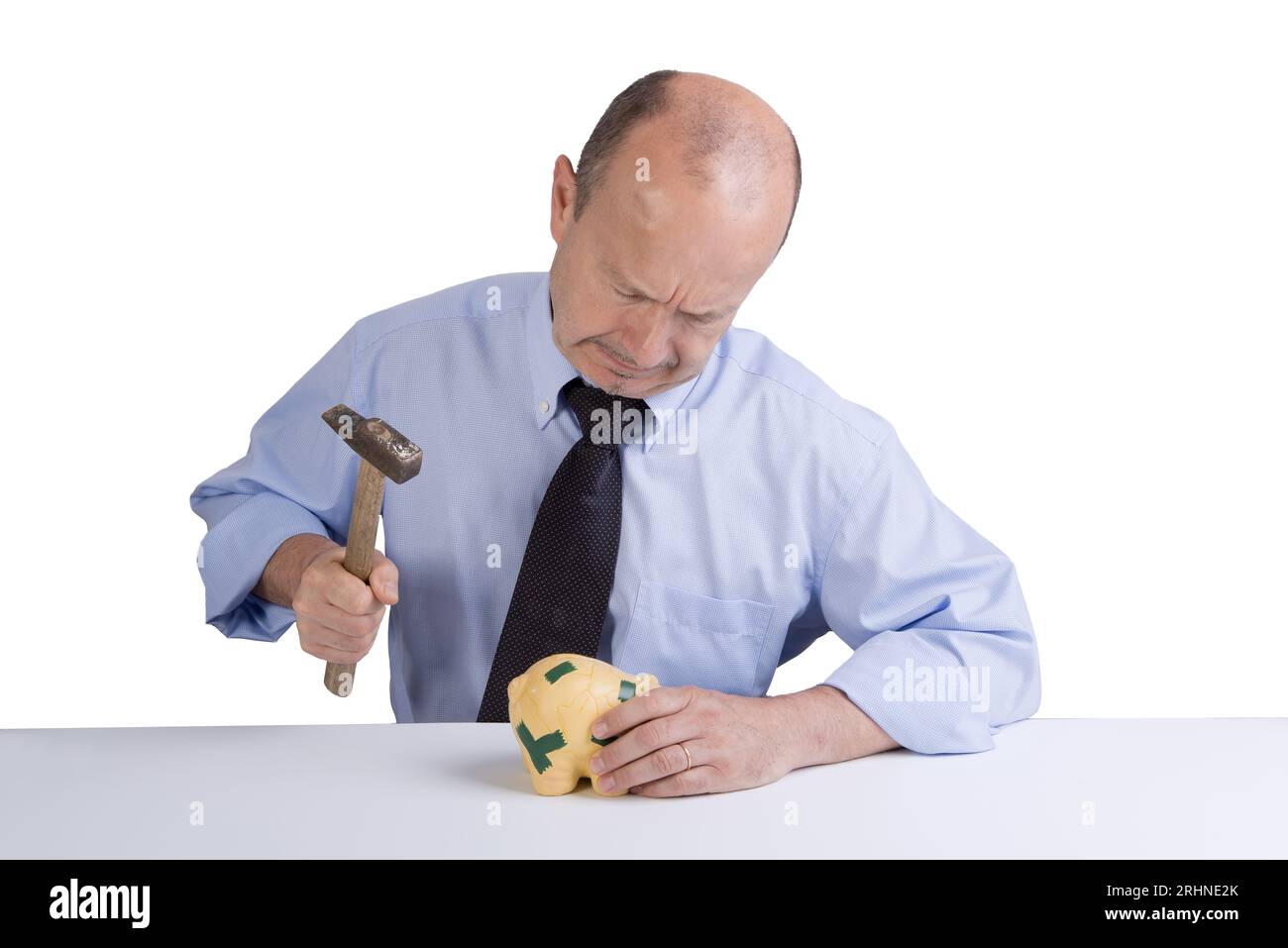 a middle-aged man breaking the piggy bank on a transparent background Stock Photo