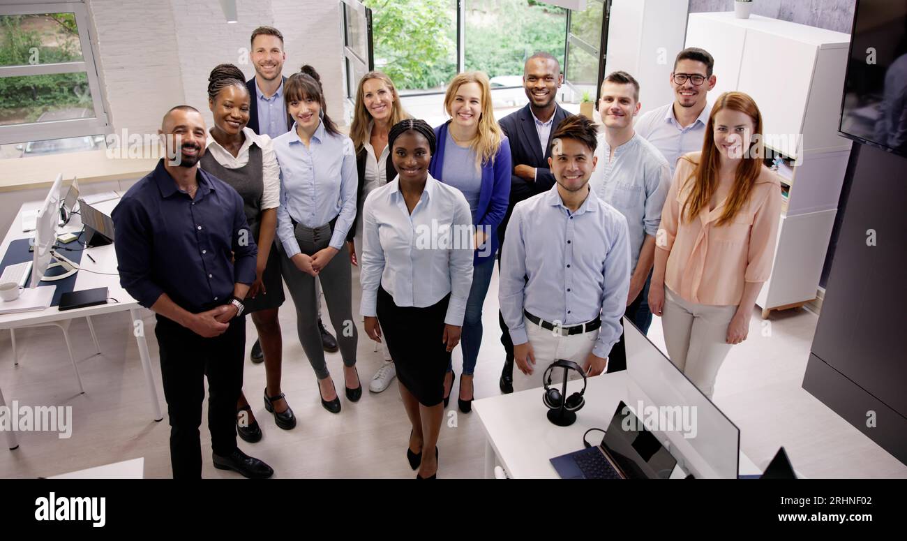 Happy Group Of Business People Standing In Office Stock Photo