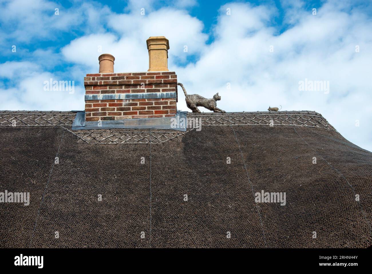 Straw cat and mouse on a thatched roof Stock Photo Alamy