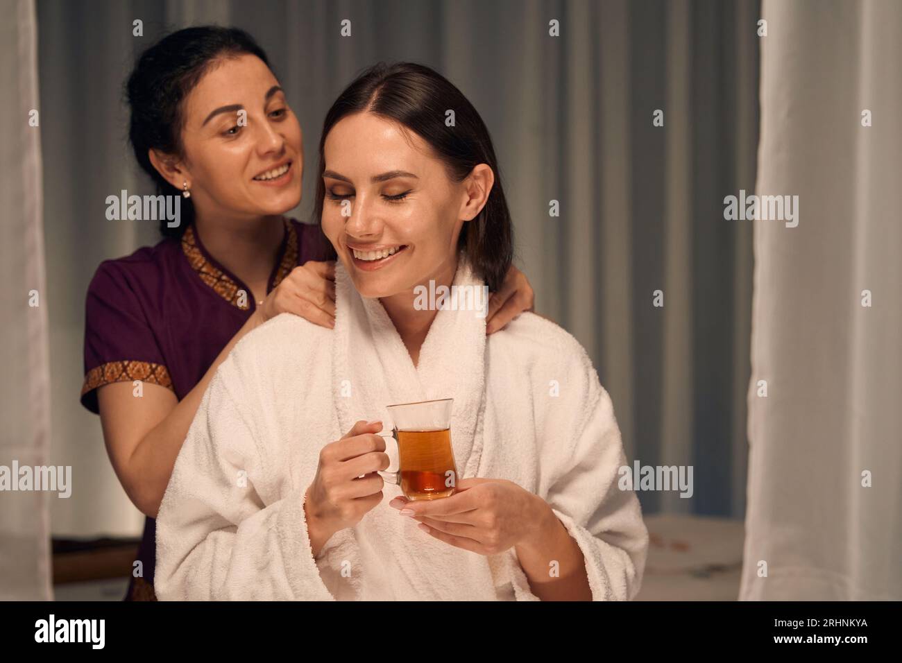 Wellness center client enjoying Thai massage therapy session Stock Photo