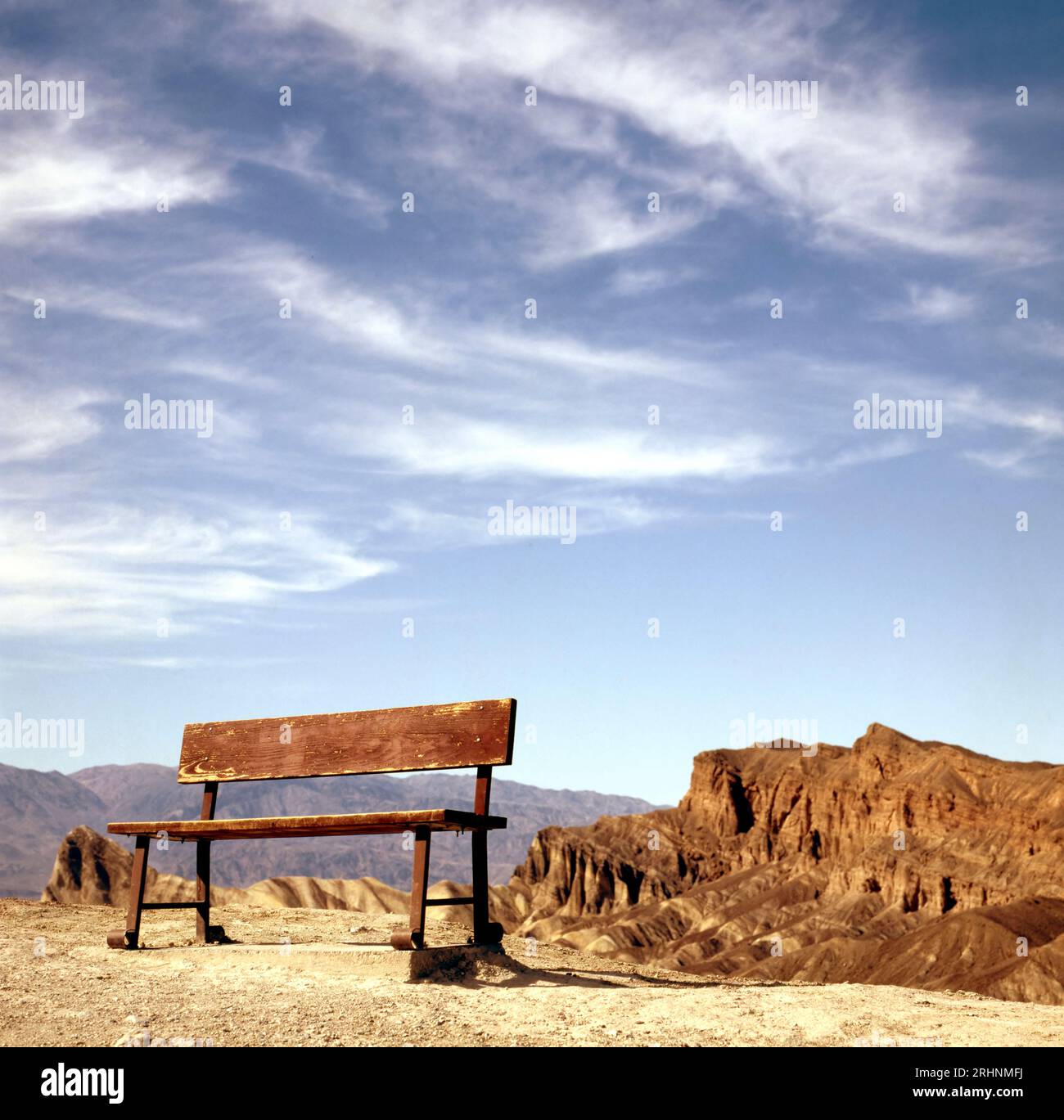 Empty bench on a hill with eroded ridges at the background. Zabriskie Point, Death Valley National Park, California, USA Stock Photo