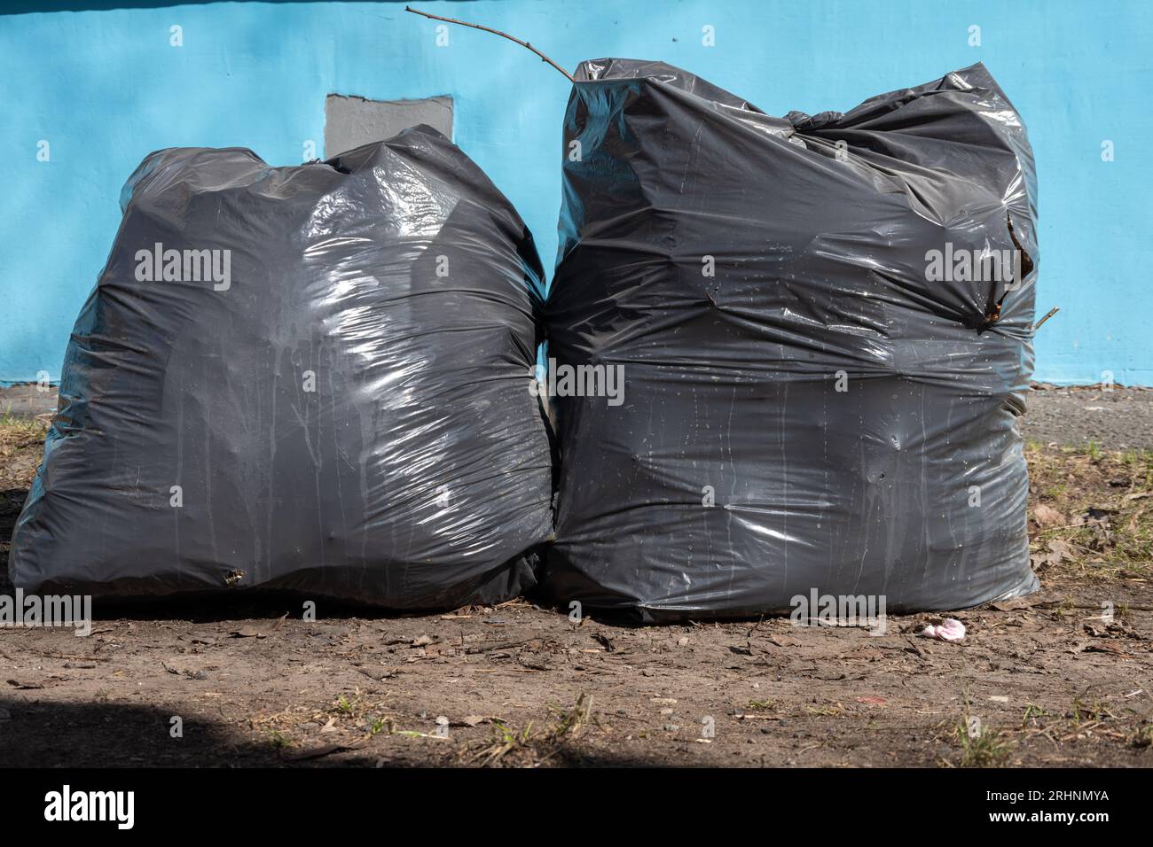 Three big blacks trash bags in front of wall Stock Photo - Alamy