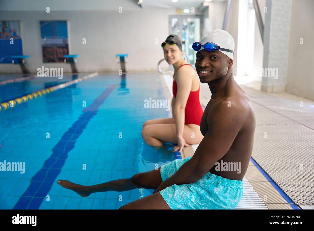 Joyous swimmers posing for camera at poolside Stock Photo