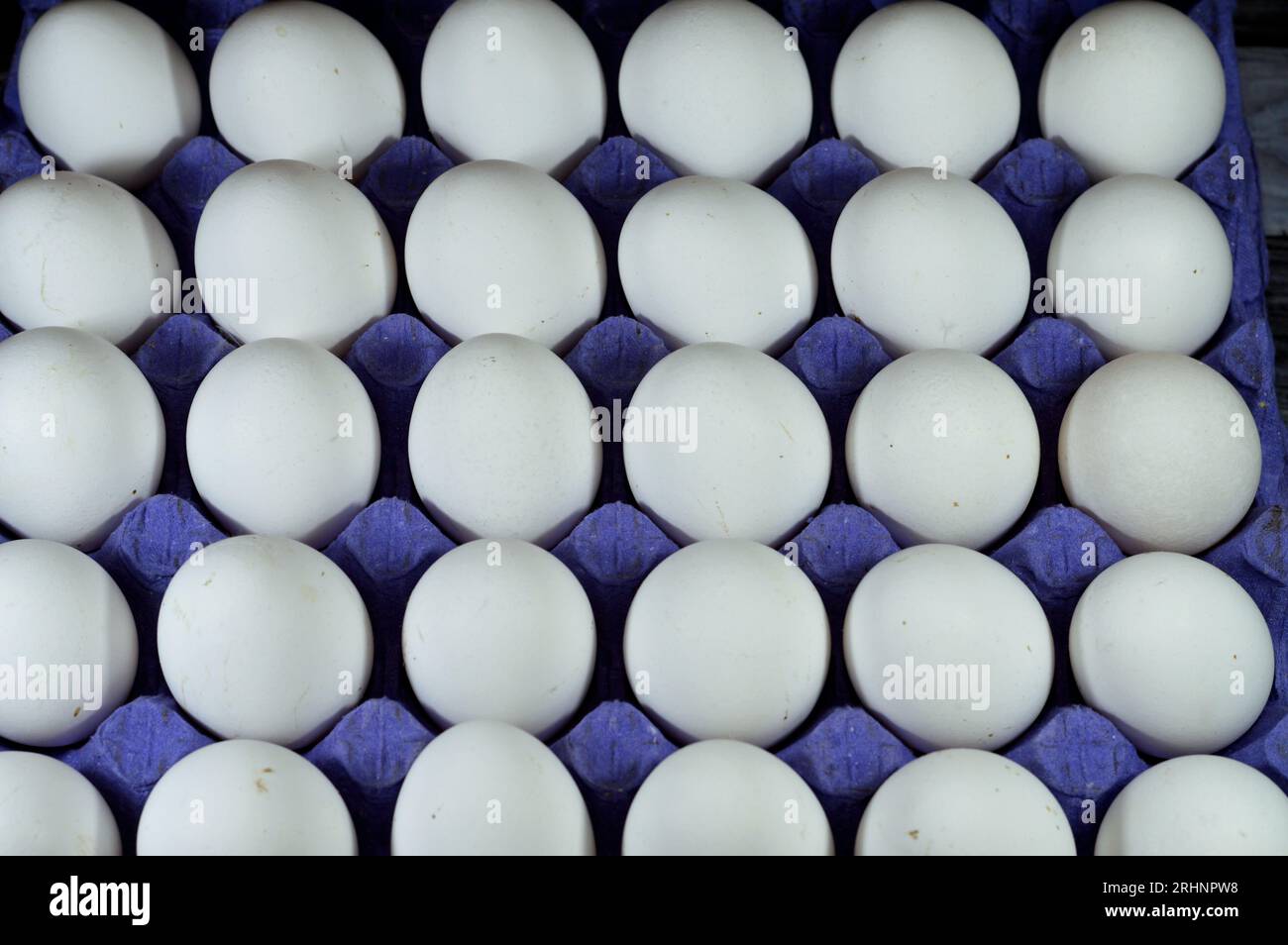 Pile of organic fresh and raw hen chicken white eggs, stack of eggs isolated and ready to be cooked in various cuisines, selective focus of eggs which Stock Photo