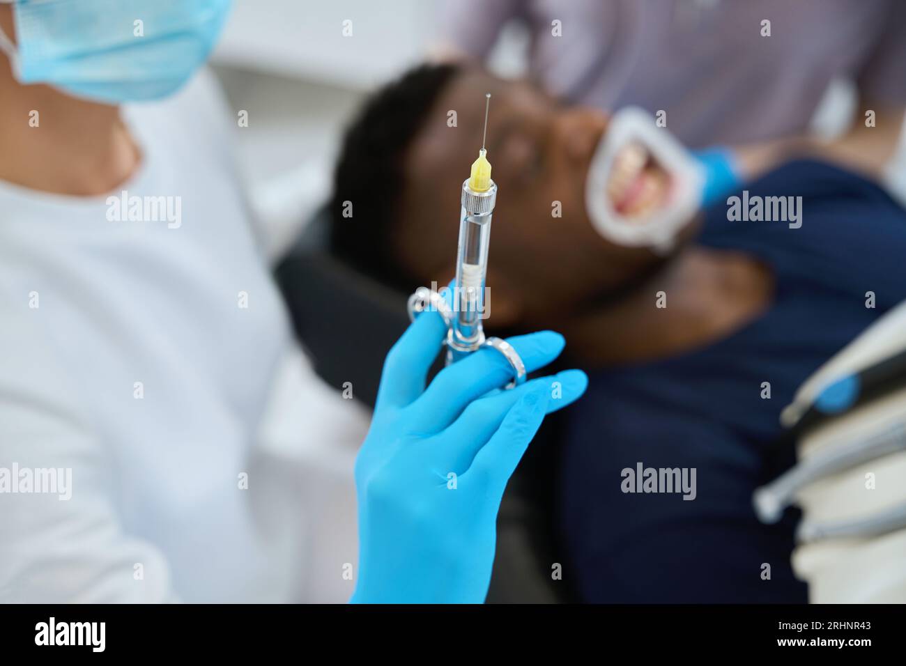 Woman dentist holding sterile syringe with anaesthetic to relief pain