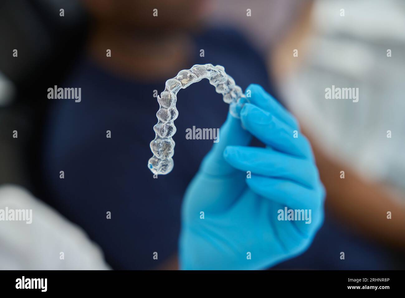 Dental aesthetic clinic worker holding clear aligners to straight teeth ...