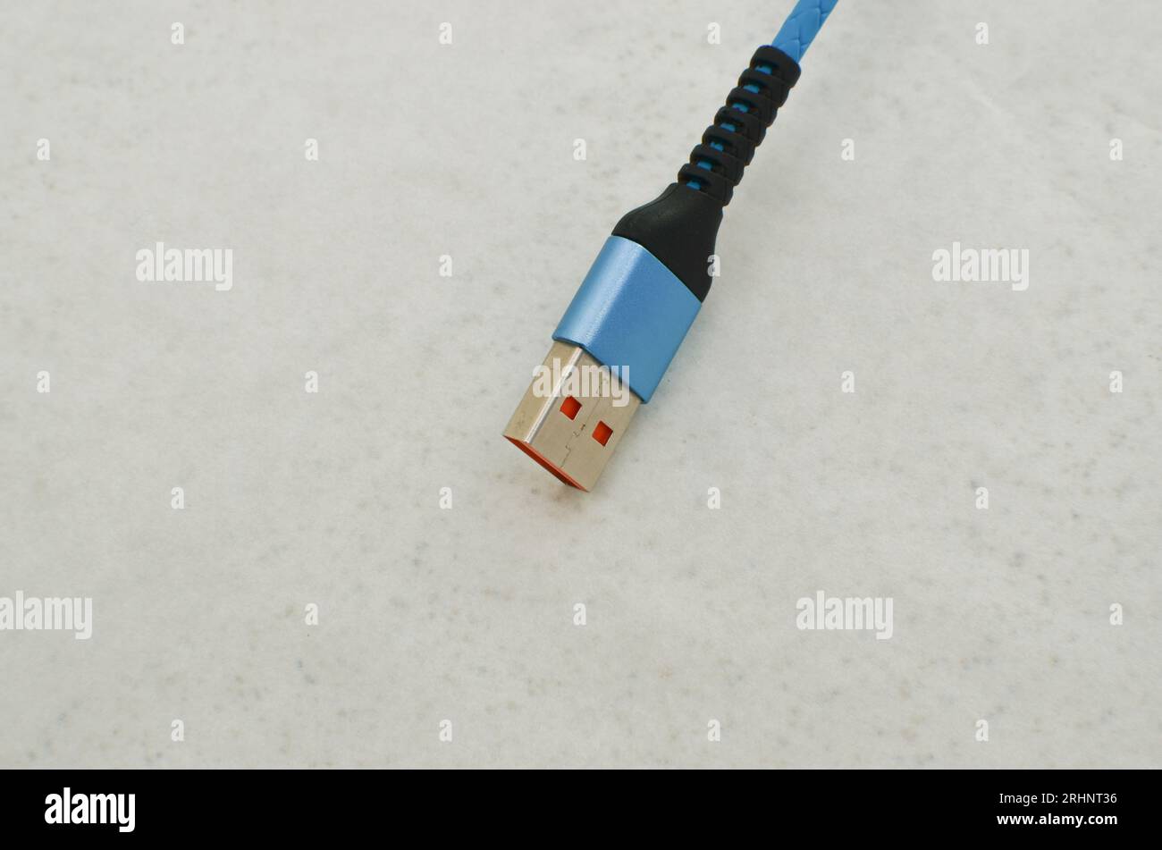 USB cable connection detail highlighted on a clear surface, perfect for modern technology concepts. Cable that provides speed and data transfer. Stock Photo