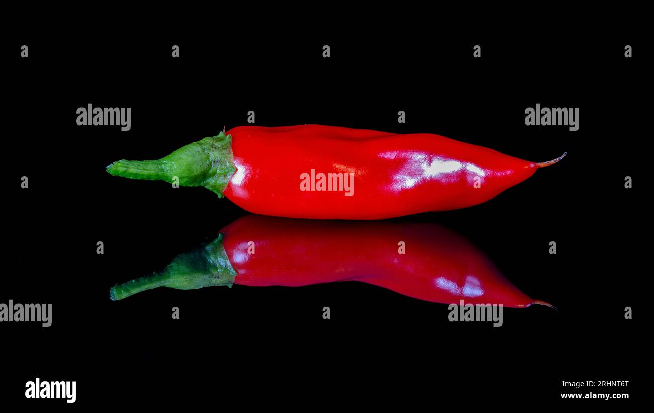 Two ripe red chili peppers isolated on white background Stock Photo - Alamy