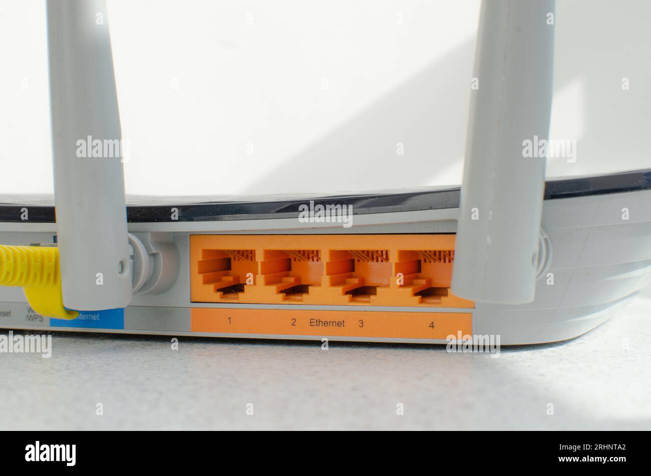Close-up detail of a modern Wi-Fi router, with multiple inputs and ...