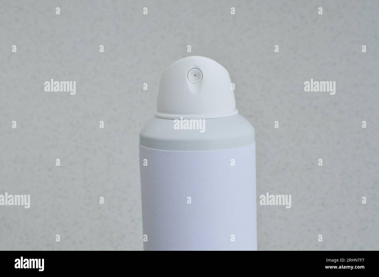 Closeup of spray deodorant with white label, conveying concepts of