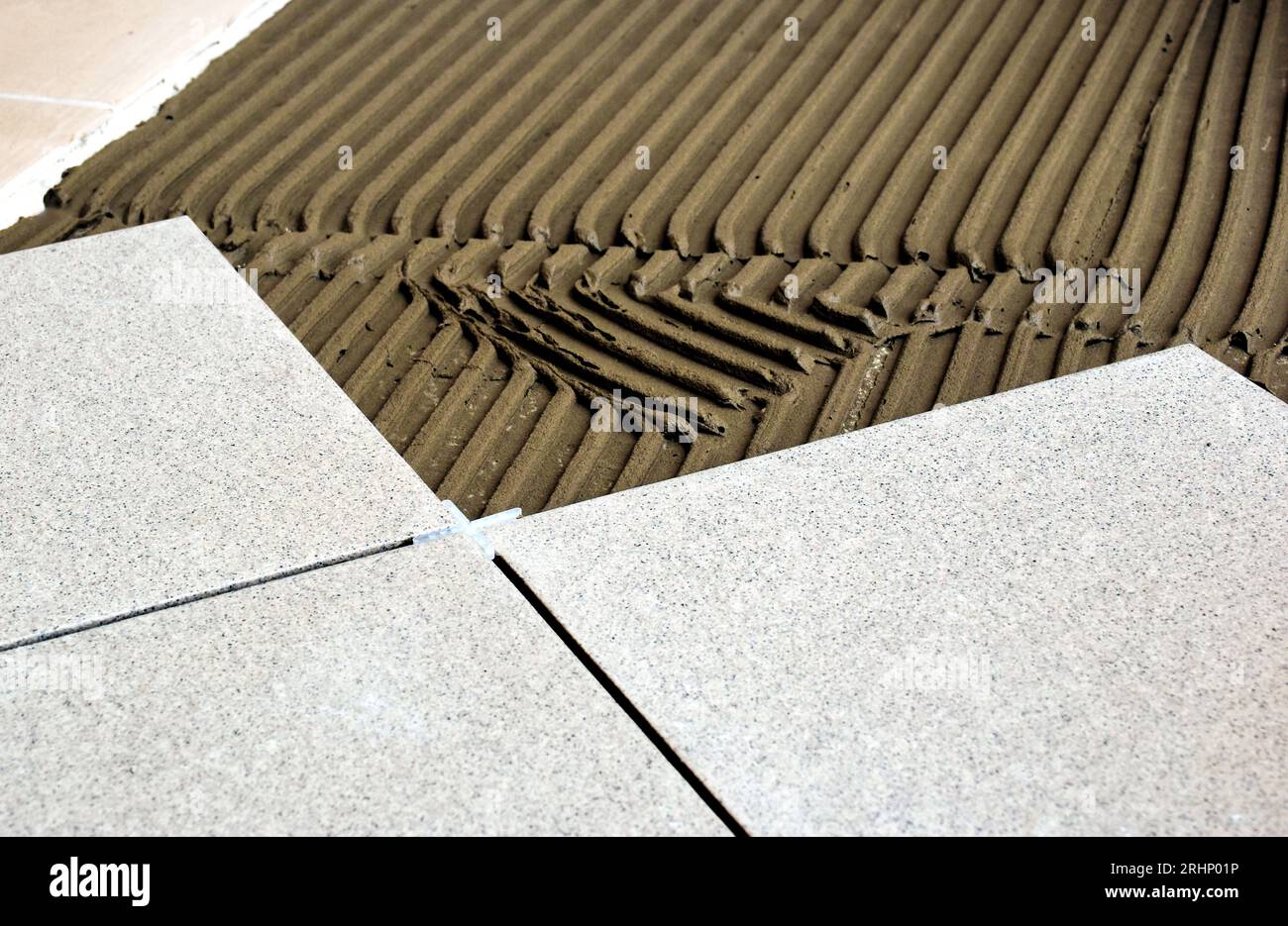 trowel on cement based grout tile base. large ceramic floor tiles