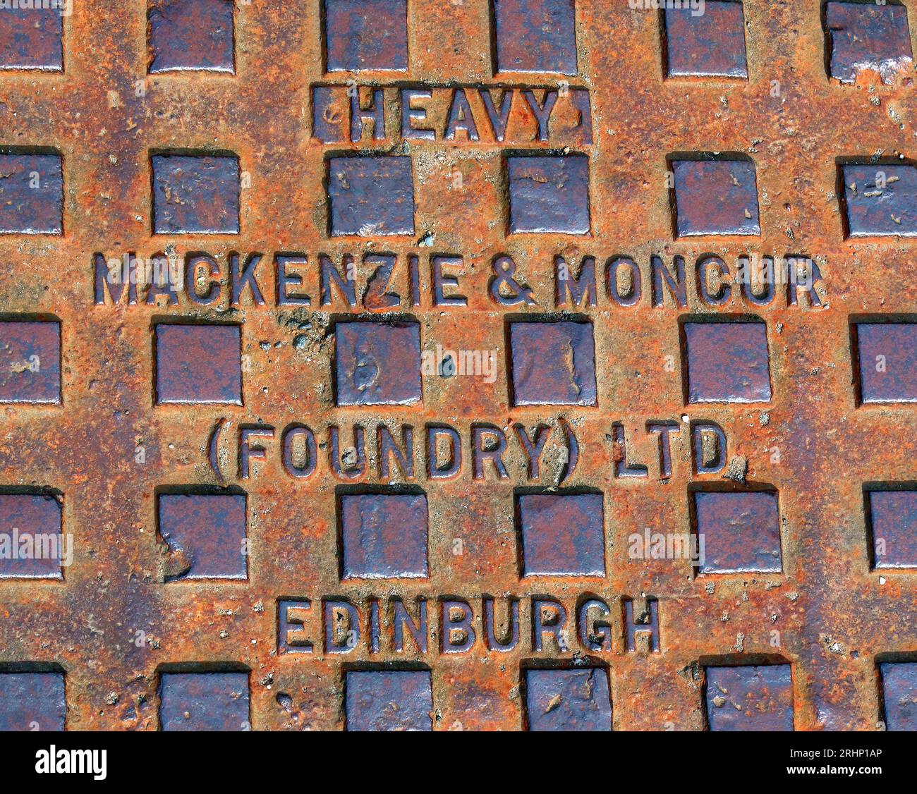 Heavy cast iron grid embossed with Mackenzie & Moncur (Foundry) Ltd, Edinburgh, Scotland, UK, EH1 3QB Stock Photo