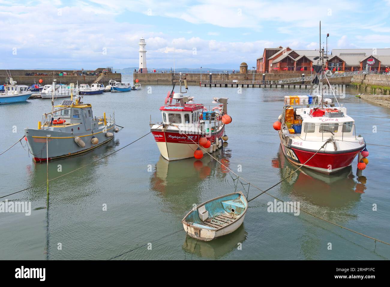 Fishing boats and vessels in sunny Newhaven harbour at high tide, Leith, Edinburgh, Scotland, UK, EH6 4LP Stock Photo
