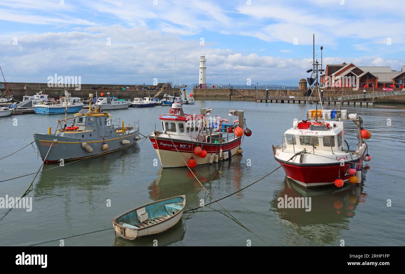 Fishing boats and vessels in sunny Newhaven harbour at high tide, Leith, Edinburgh, Scotland, UK, EH6 4LP Stock Photo