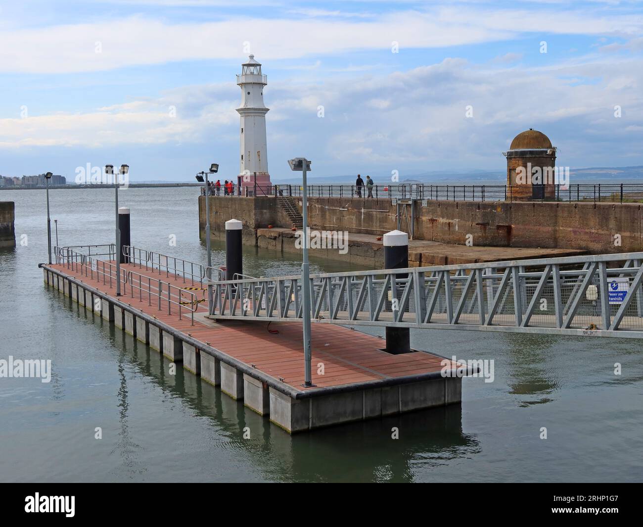 Sunny Newhaven harbour and landing stage, at high tide, Leith, Edinburgh, Scotland, UK, EH6 4LP Stock Photo