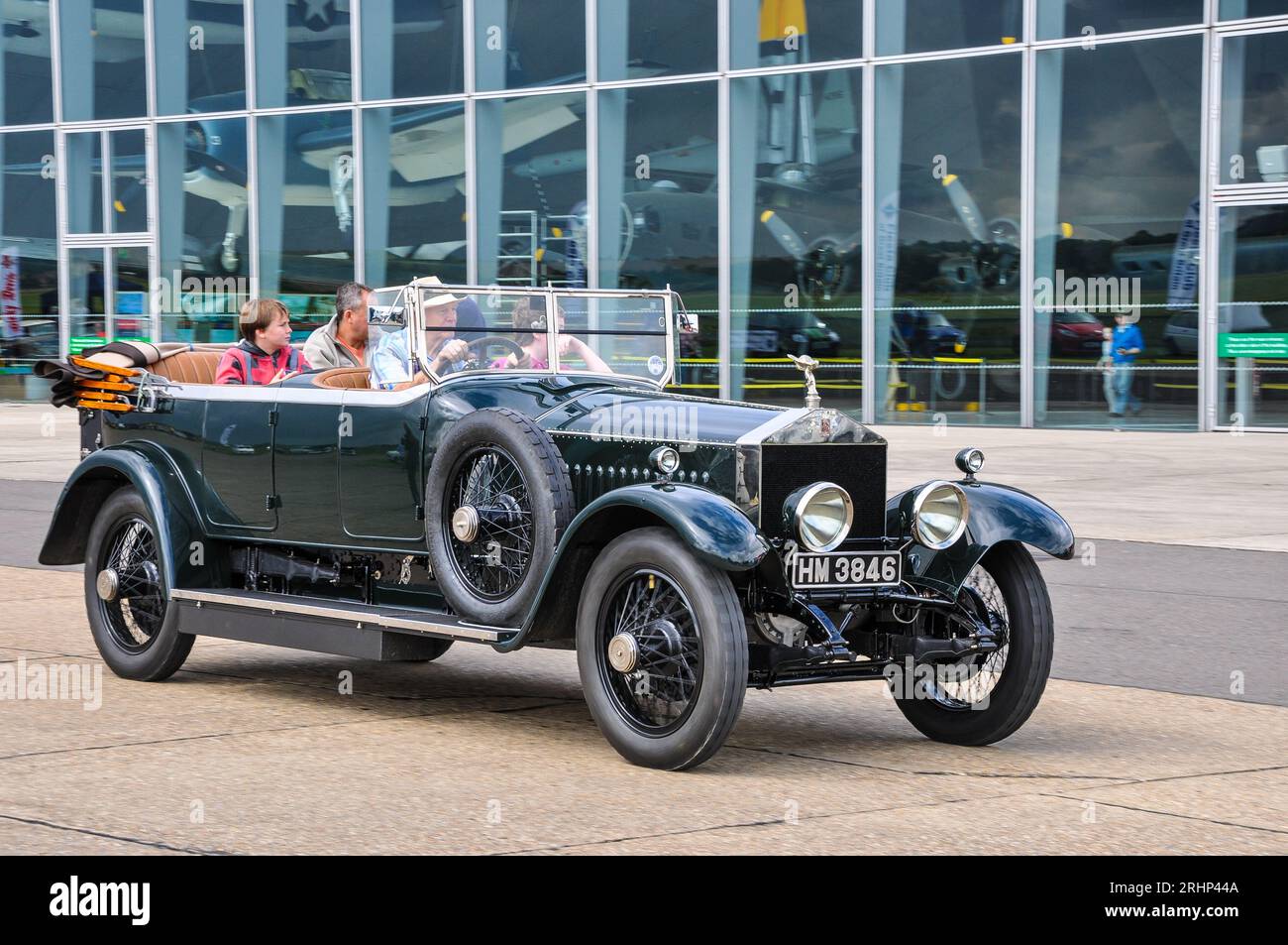 1924 Rolls Royce classic car driving passed the American Air Museum at IWM Duxford, Cambridgeshire, UK. Stock Photo