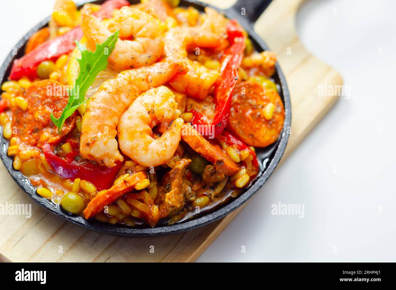 Delicious paella, cooked risotto rice with chicken thigh, king prawns ...