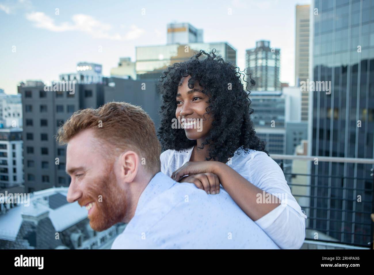 Couple against big city backdrop Stock Photo