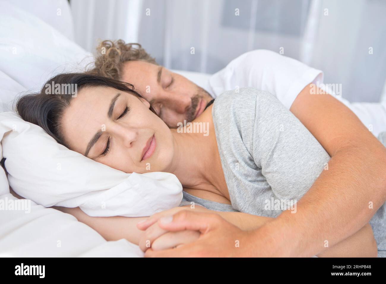 sleeping middle aged couple Stock Photo