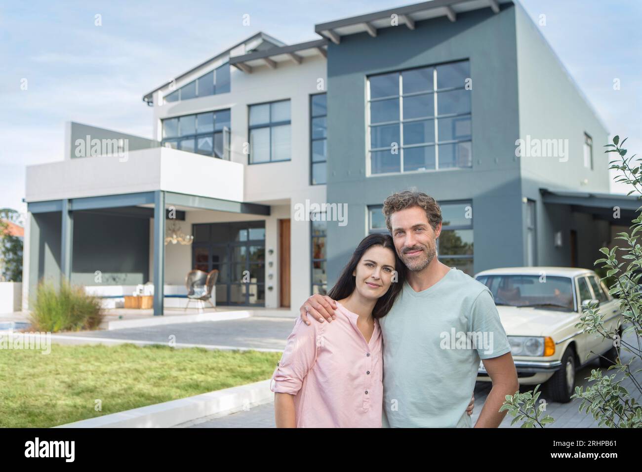 Couple in front of home Stock Photo