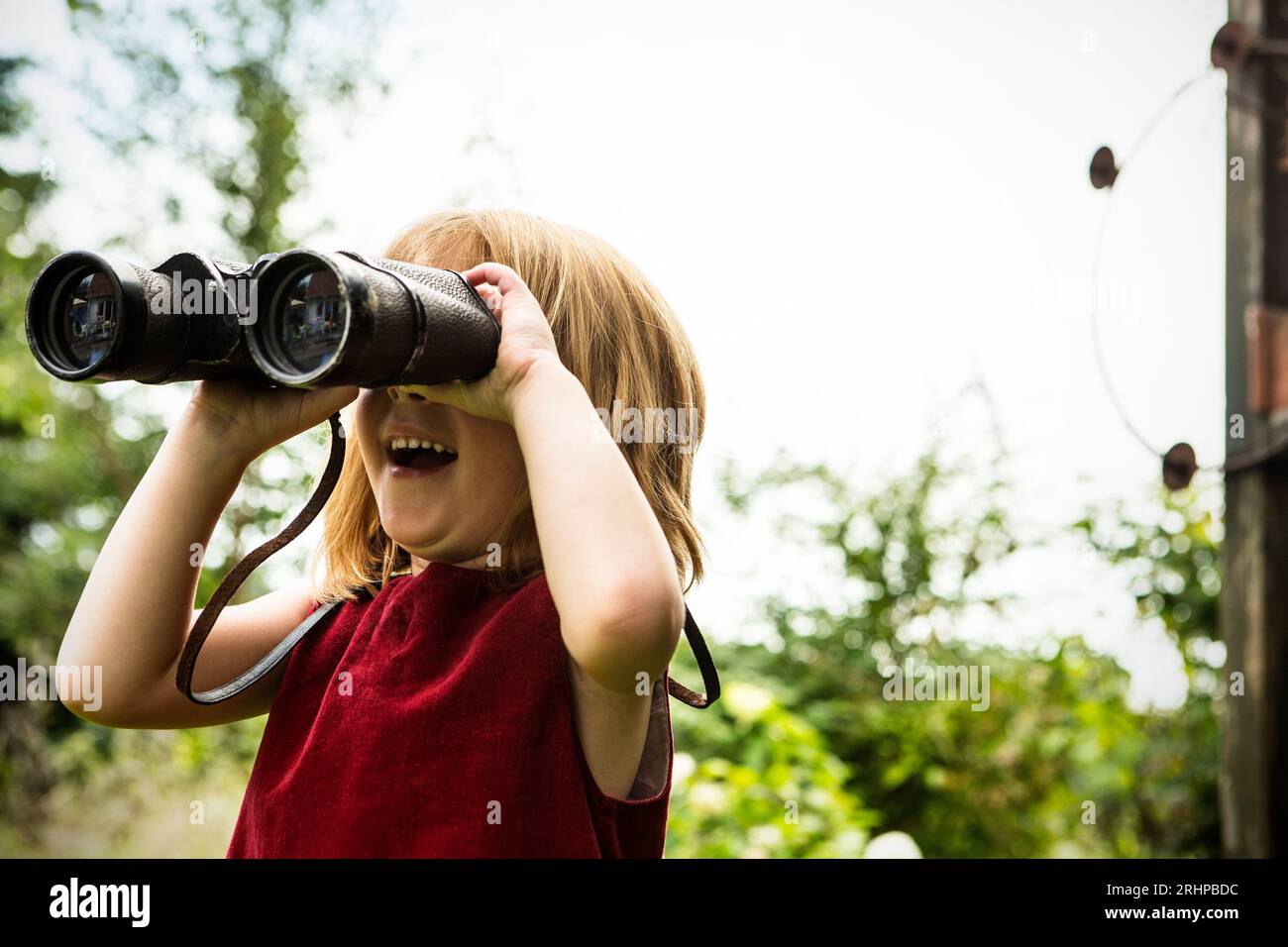 Girl with binoculars Stock Photo