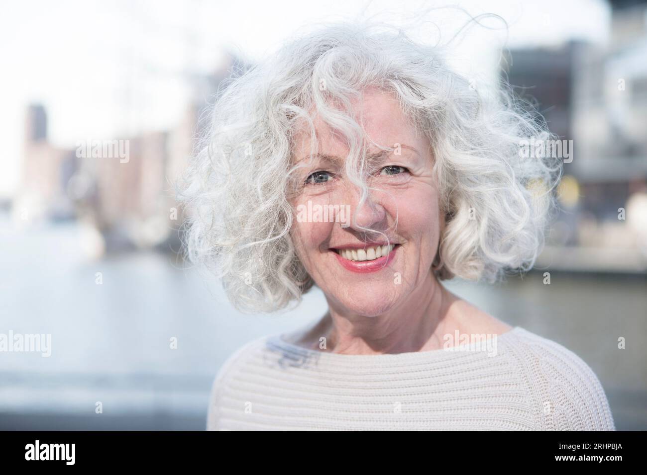 Smiling woman standing port hamburg hi-res stock photography and images ...