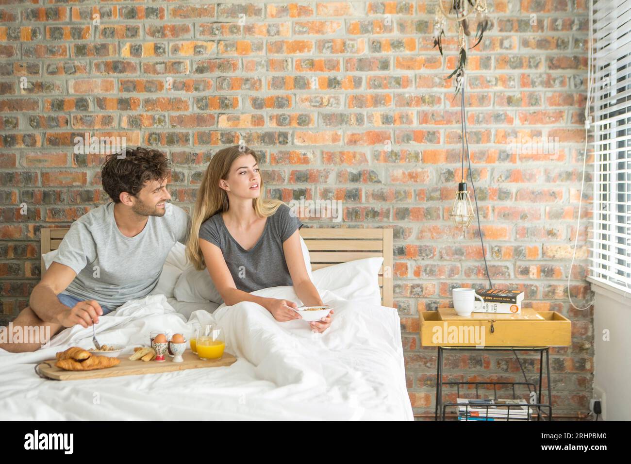 Couple having breakfast in bed Stock Photo