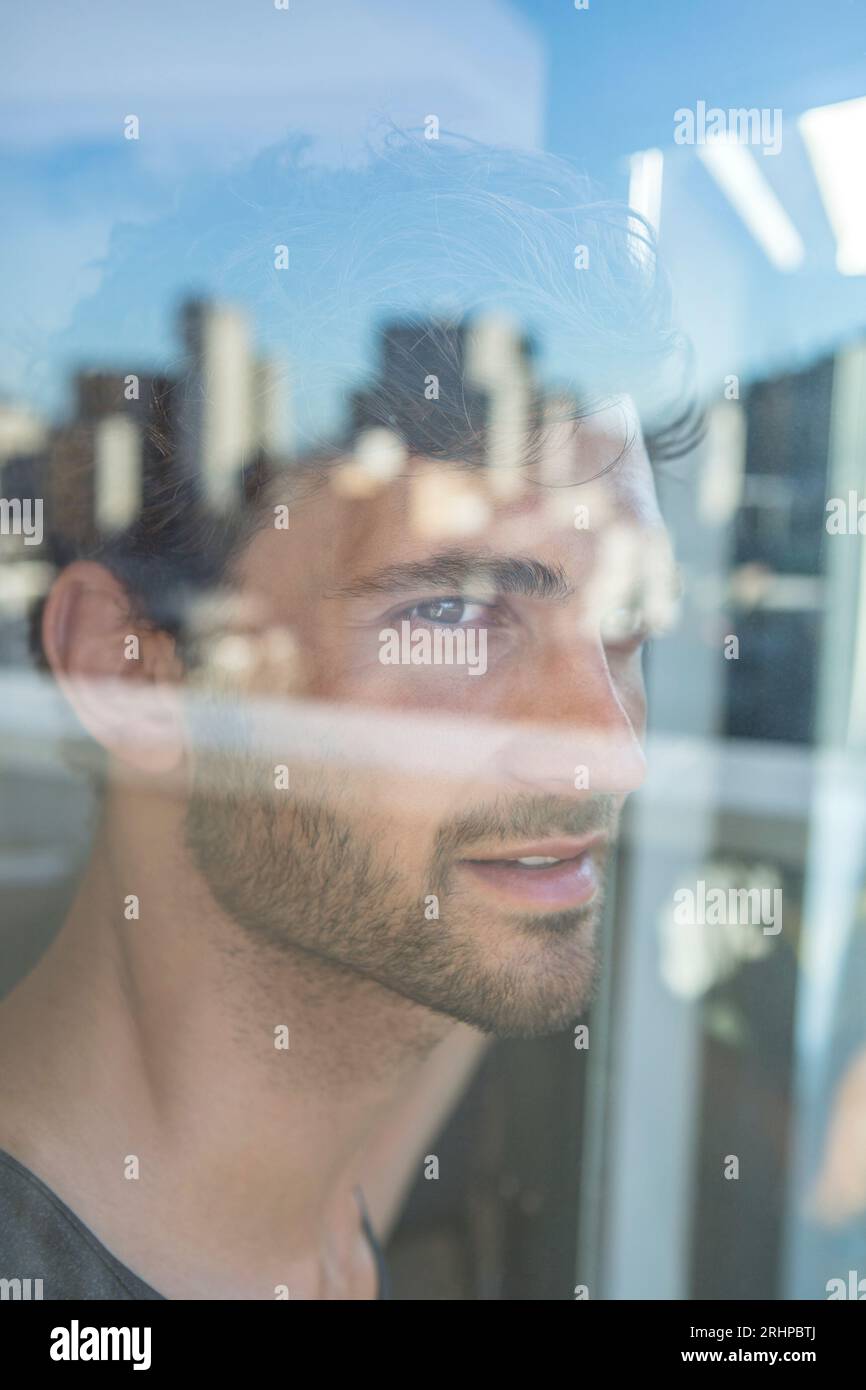 Man looks at the window Stock Photo