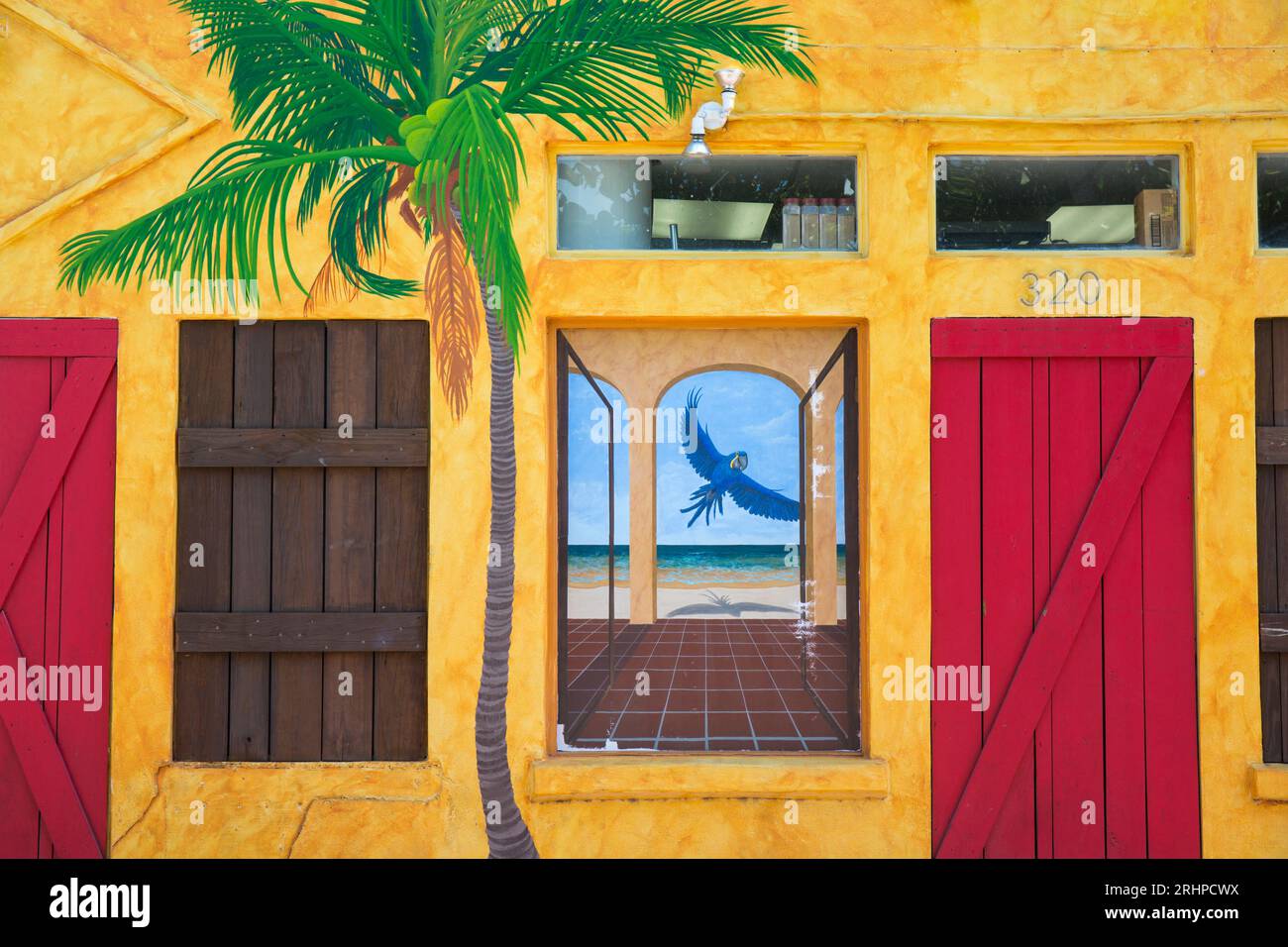 Key West, Florida, USA. Colourful facade of the Blue Macaw, a popular cocktail bar, Bahama Village, Old Town. Stock Photo
