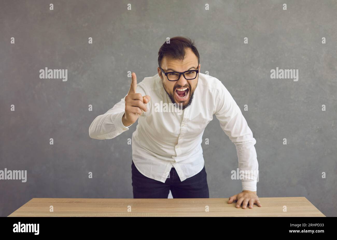 Angry young man pointing his finger at the camera, shouting at you and blaming you Stock Photo