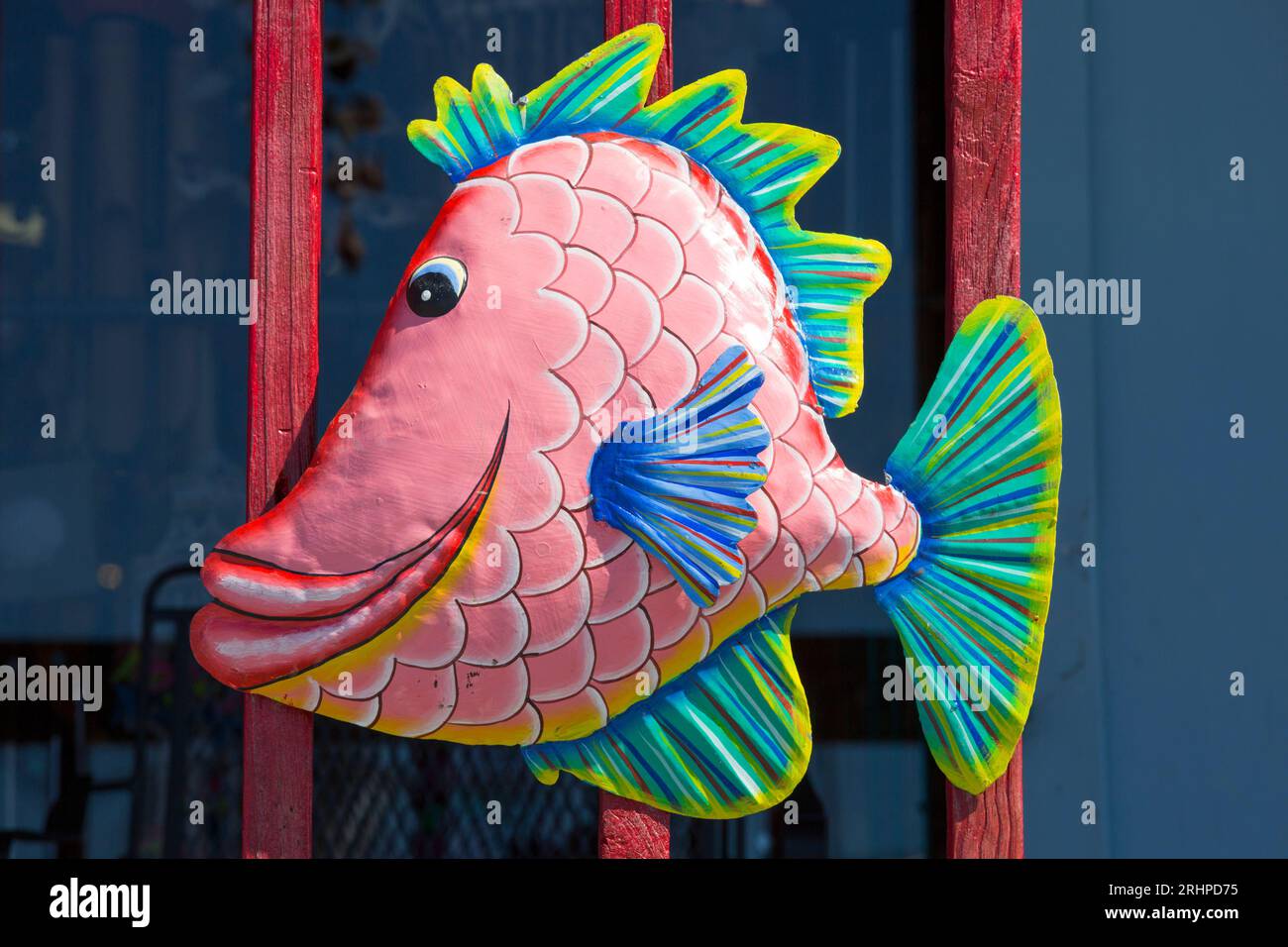Naples, Florida, USA. Colourful cartoon fish ornament attached to wooden balcony of the Shell Shack, a popular souvenir and gift shop. Stock Photo