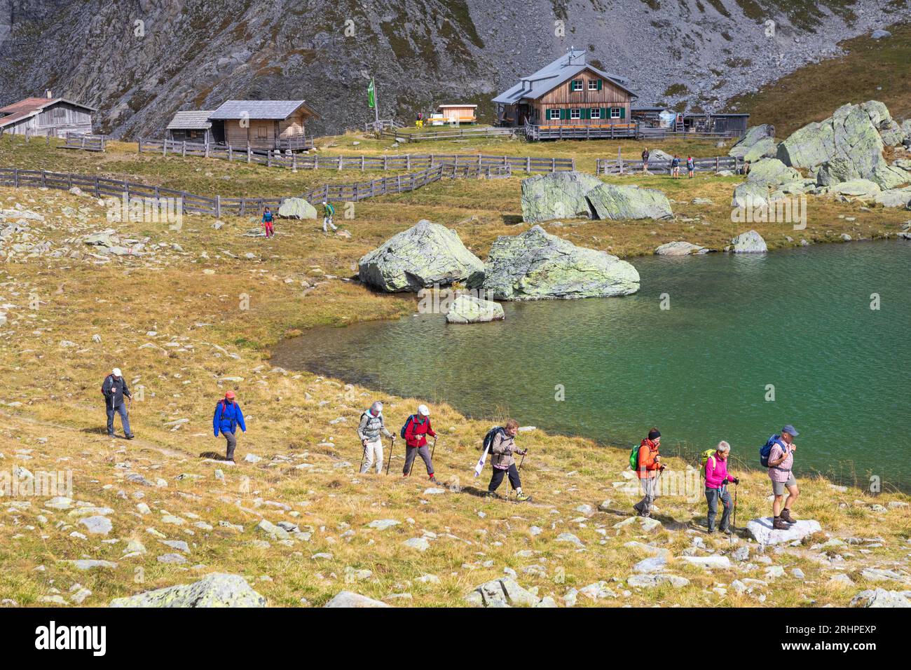 Austria, East Tyrol, district of Lienz, Kartitsch. hikers passing in front of the hut Obstansersee Hütte in the Carnic Alps Stock Photo
