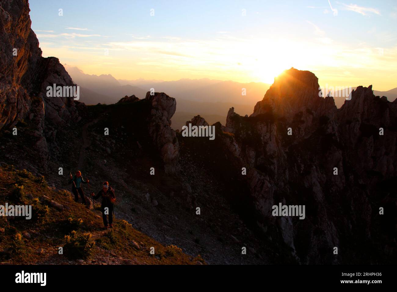 2 young women hiking to Viererspitze 2054 m, in sunset, Karwendel, Germany, Bavaria, Upper Bavaria, Werdenfelser Land, Isartal, Mittenwald Stock Photo